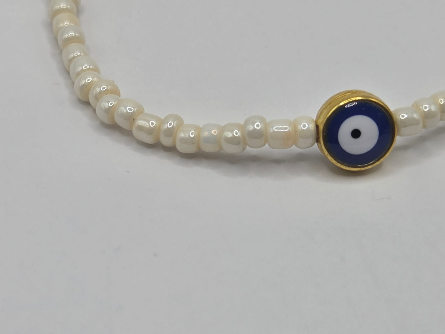 Beige bracelet with Evil Eye