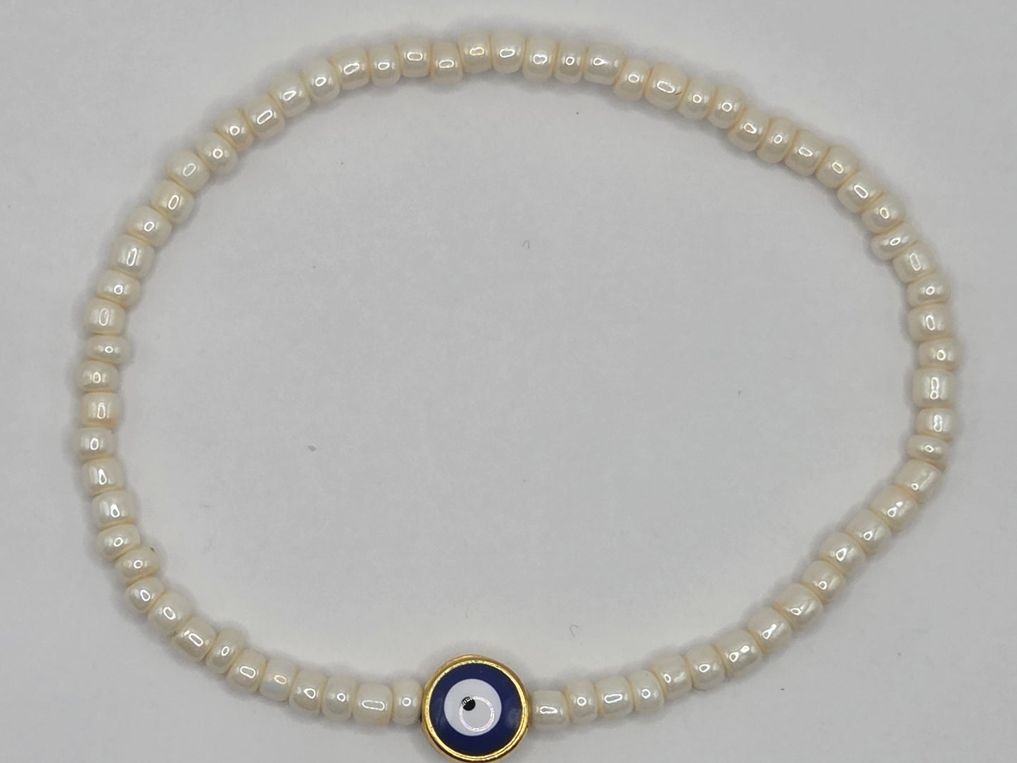 Beige bracelet with Evil Eye