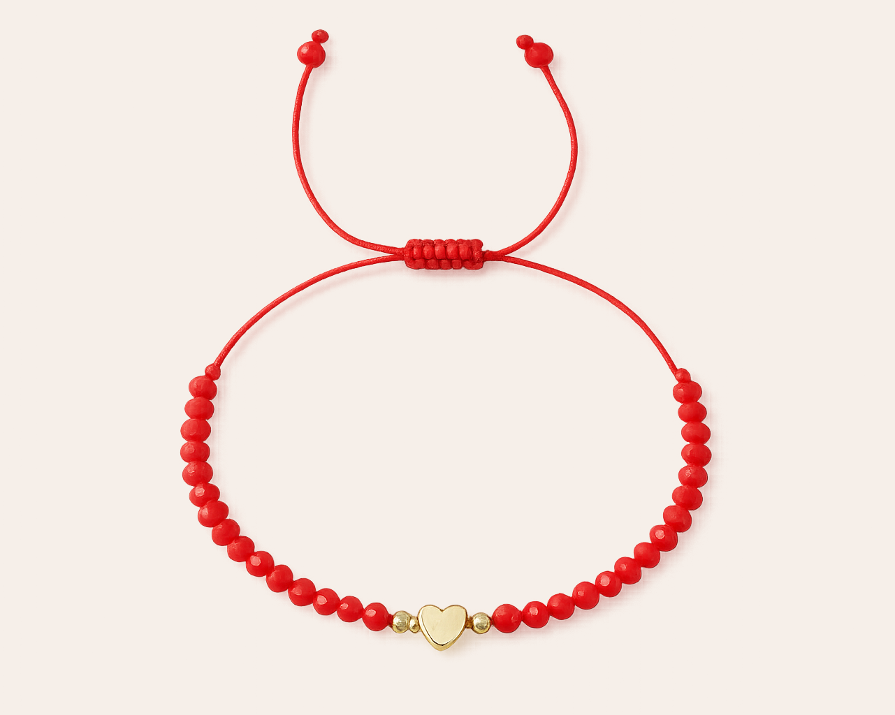 Red bracelet with gold heart charm