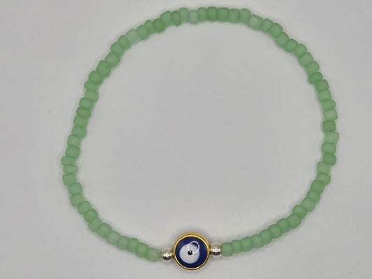Handmade bracelet in mint green with Evil Eye – delicate protective jewelry