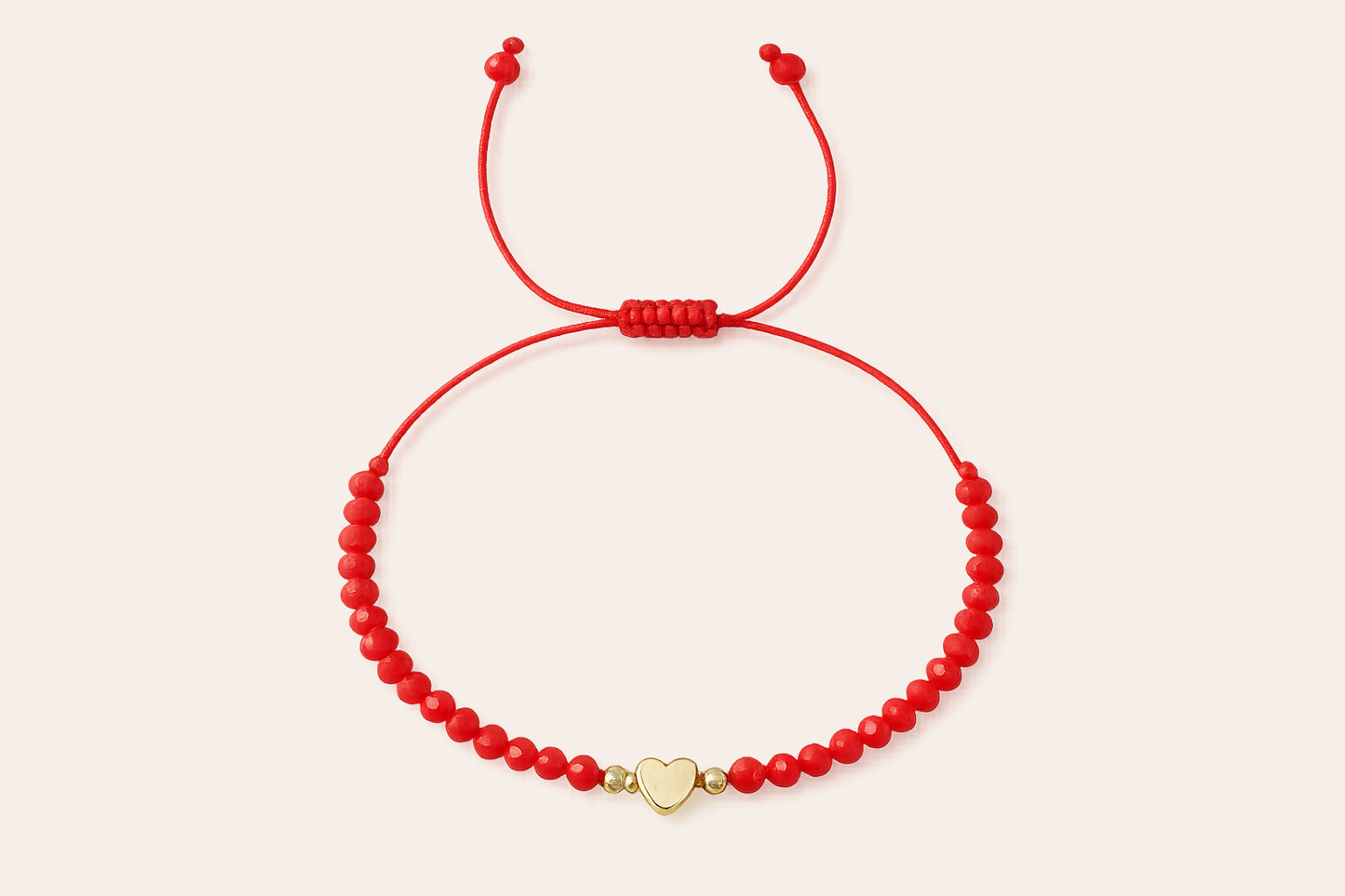 Red bracelet with gold heart charm