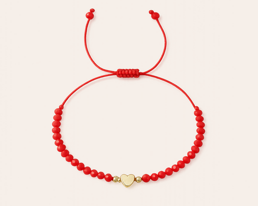 Red bracelet with gold heart charm
